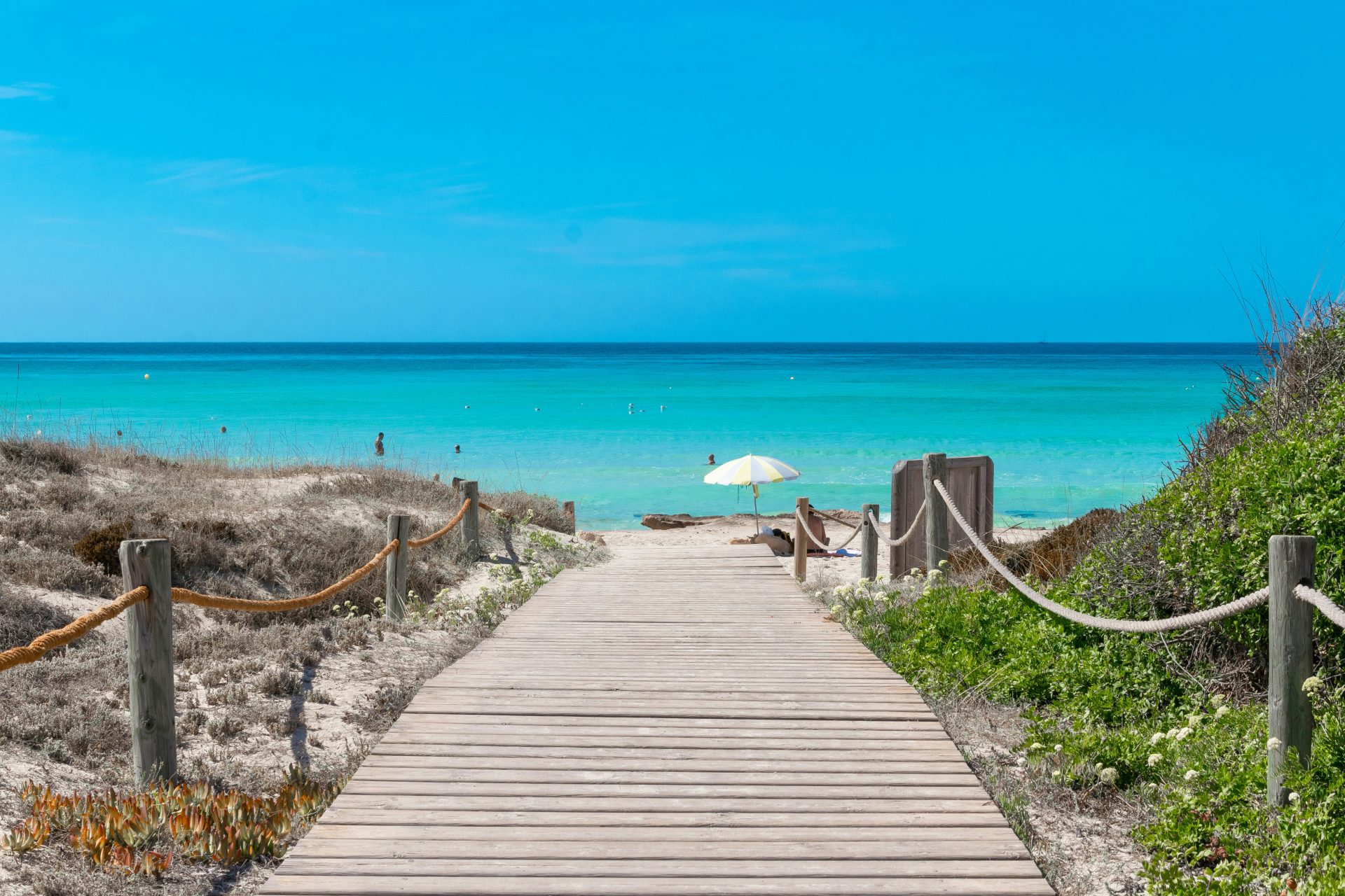 a wooden walkway to a beach